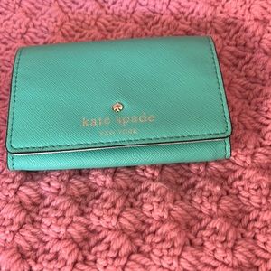 Kate, spade, small card holder wallet with interior in gold in turquoise color